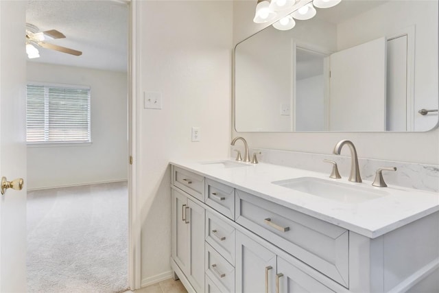 2009 Barnett Dr, Cedar Park, TX 78613 - bathroom with double vanity, a ceiling fan, and baseboards