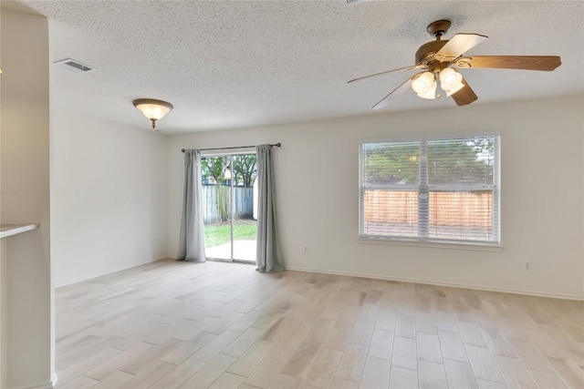 2009 Barnett Dr, Cedar Park, TX 78613 - empty room with light wood-style flooring, a ceiling fan, a textured ceiling, and baseboards