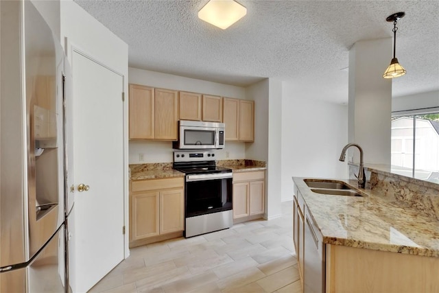 2009 Barnett Dr, Cedar Park, TX 78613 - kitchen featuring appliances with stainless steel finishes, light brown cabinets, a sink, light stone countertops, and a textured ceiling