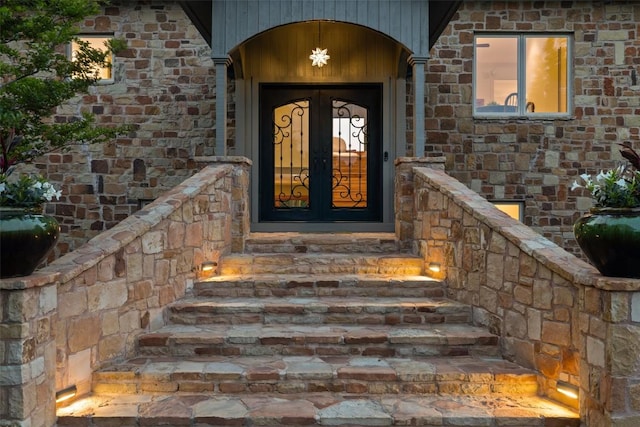 doorway to property with stone siding