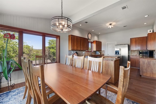 dining area with an inviting chandelier, dark wood-style flooring, visible vents, and recessed lighting