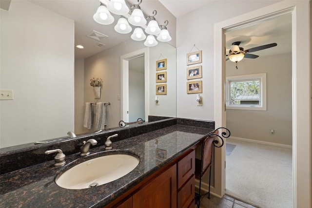 bathroom with baseboards, a ceiling fan, and vanity