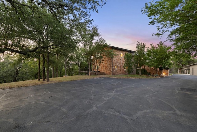 exterior space featuring brick siding and driveway