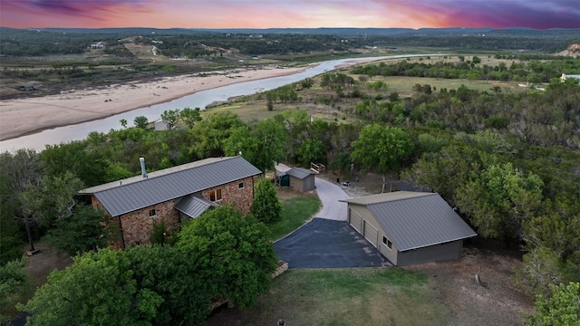 aerial view at dusk with a water view