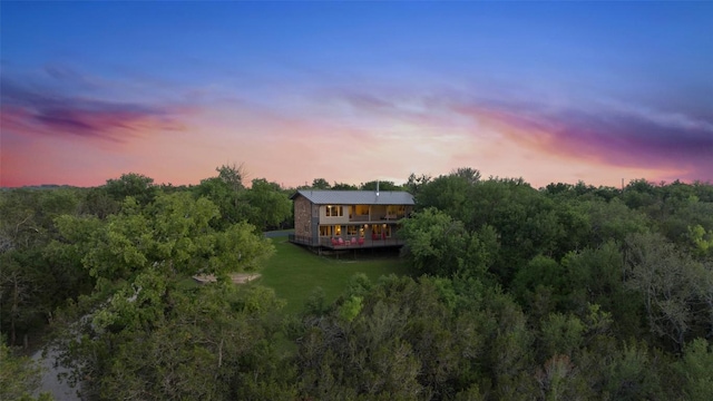 aerial view at dusk with a view of trees
