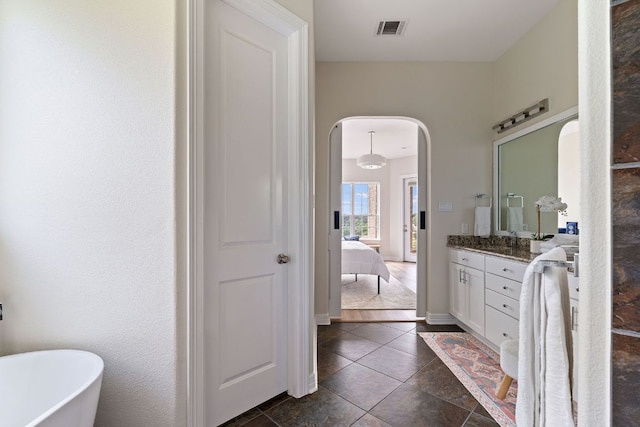 3207 Crystal Falls Pkwy, Leander, TX 78641 - ensuite bathroom with visible vents, vanity, ensuite bathroom, tile patterned floors, and a soaking tub