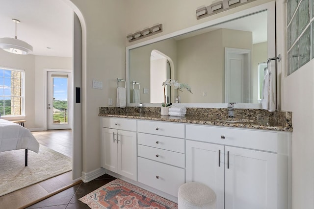 3207 Crystal Falls Pkwy, Leander, TX 78641 - ensuite bathroom featuring tile patterned flooring, double vanity, baseboards, connected bathroom, and a sink