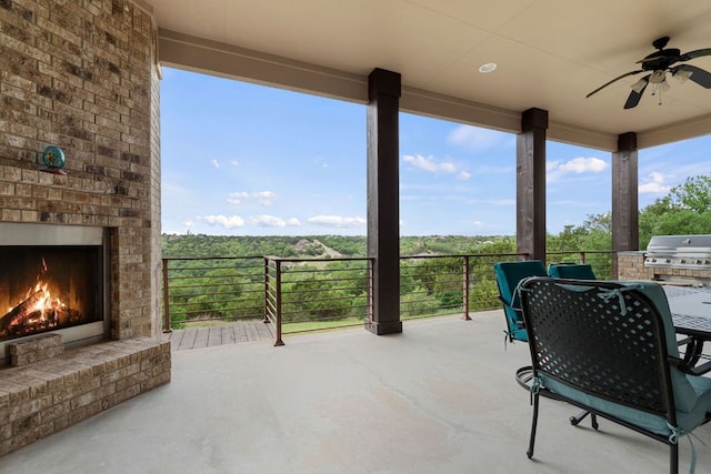3207 Crystal Falls Pkwy, Leander, TX 78641 - view of patio with a ceiling fan, outdoor dining area, an outdoor brick fireplace, and a grill