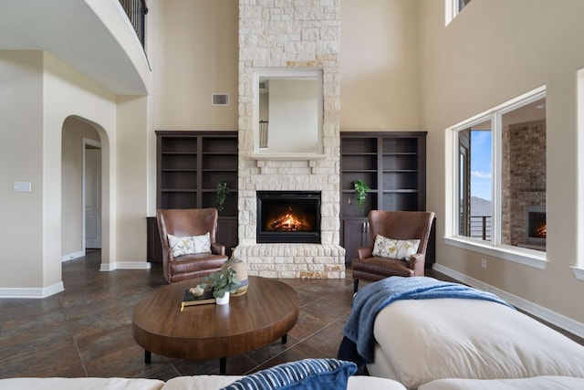 3207 Crystal Falls Pkwy, Leander, TX 78641 - living area with a high ceiling, visible vents, and a fireplace
