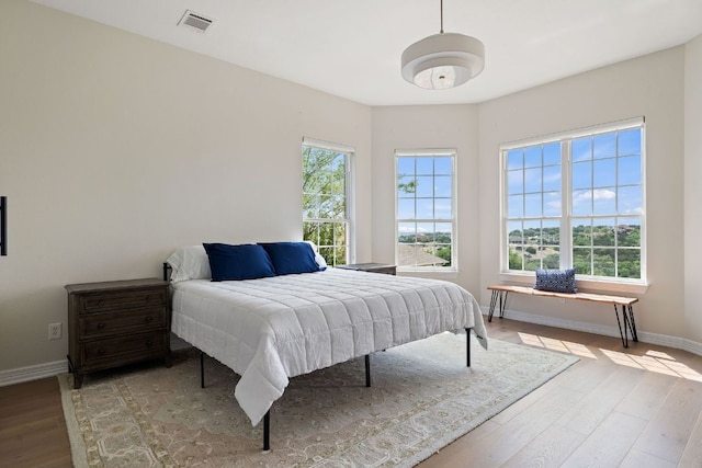 3207 Crystal Falls Pkwy, Leander, TX 78641 - bedroom featuring baseboards, visible vents, and wood finished floors