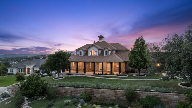 3207 Crystal Falls Pkwy, Leander, TX 78641 - back of house with a yard, brick siding, and a porch