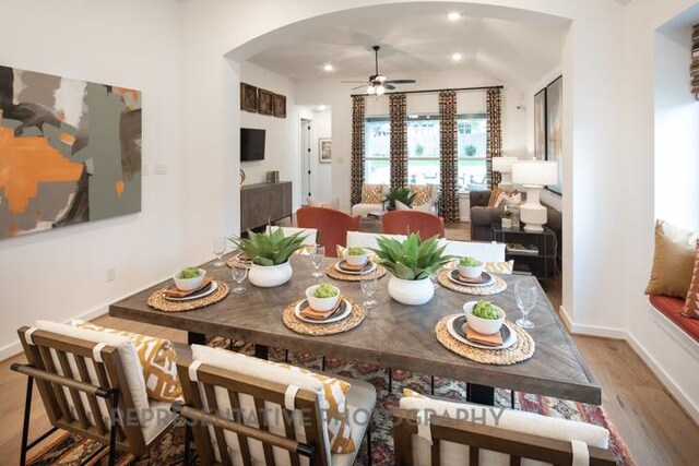 321 Dycus Bnd, Liberty Hill, TX 78642 - dining room featuring arched walkways, ceiling fan, wood finished floors, lofted ceiling, and recessed lighting