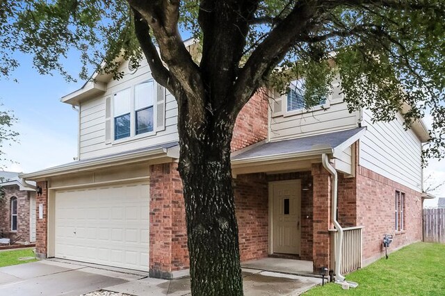 17928 Honey Locust Ln, Elgin, TX 78621 - view of front of property with an attached garage, brick siding, and driveway