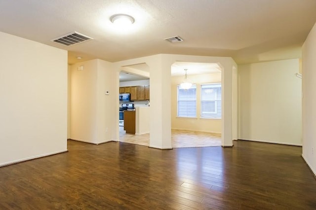 17928 Honey Locust Ln, Elgin, TX 78621 - empty room featuring dark wood-style flooring and arched walkways