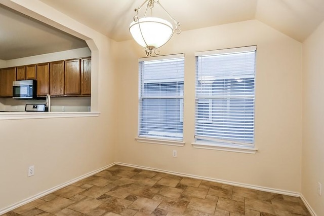 17928 Honey Locust Ln, Elgin, TX 78621 - unfurnished dining area with stone finish floors and baseboards