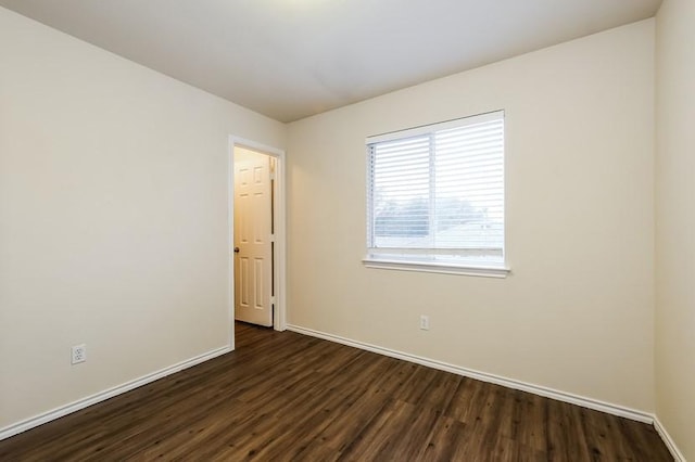17928 Honey Locust Ln, Elgin, TX 78621 - spare room featuring dark wood-style floors and baseboards