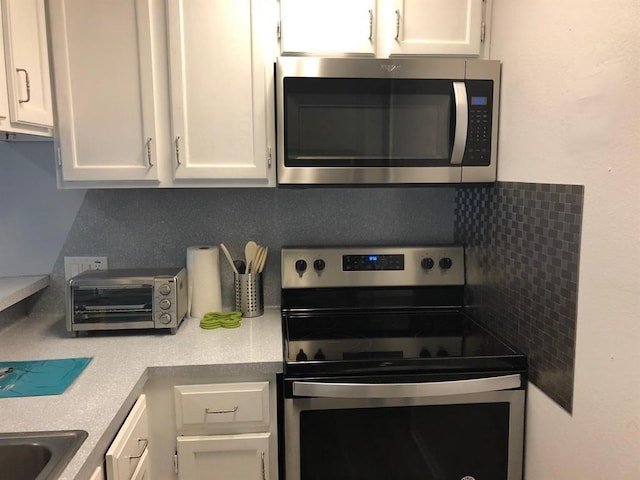 2815 Rio Grande St Unit 201, Austin, TX 78705 - kitchen featuring white cabinetry, stainless steel appliances, and light countertops