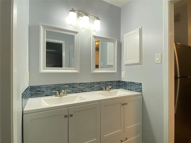 2815 Rio Grande St Unit 201, Austin, TX 78705 - bathroom with double vanity, backsplash, and a sink