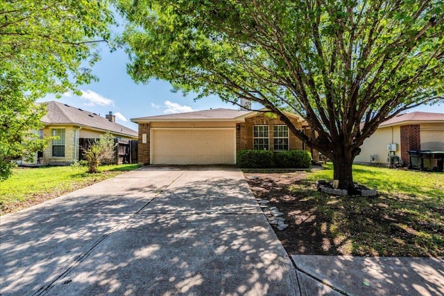 109 David Dr, Hutto, TX 78634 - ranch-style house with an attached garage, driveway, a front lawn, and brick siding