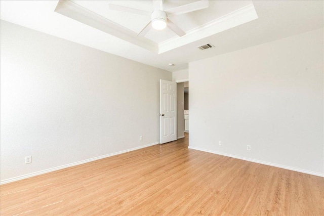 109 David Dr, Hutto, TX 78634 - unfurnished room featuring a raised ceiling, light wood-style flooring, baseboards, and ceiling fan