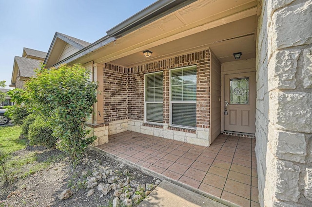 property entrance featuring brick siding