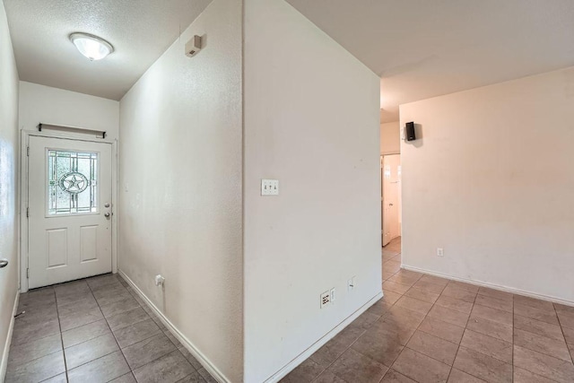 interior space with tile patterned floors and baseboards