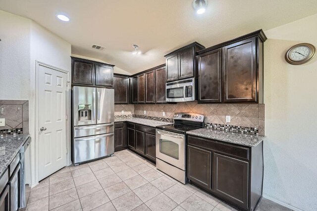 kitchen featuring appliances with stainless steel finishes, visible vents, and decorative backsplash