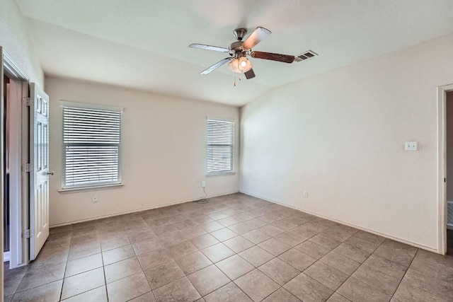 unfurnished room with a healthy amount of sunlight, visible vents, light tile patterned floors, and ceiling fan