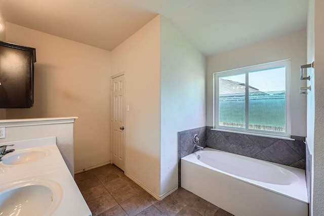 full bath featuring tile patterned flooring, a bath, double vanity, and a sink