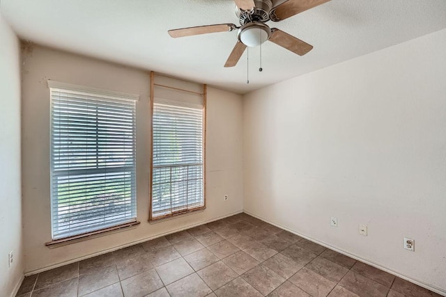spare room featuring plenty of natural light and a ceiling fan