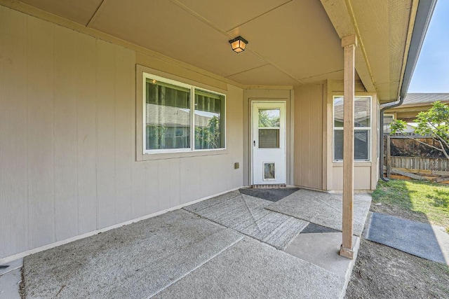 view of exterior entry with a patio area