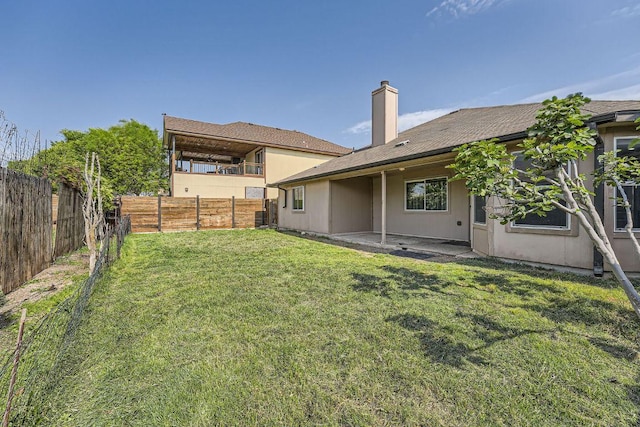 view of yard with a patio area and a fenced backyard