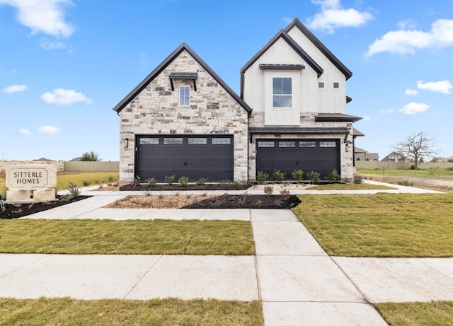 109 Flora Springs Cv, Liberty Hill, TX 78642 - view of front of home featuring a garage, board and batten siding, a front yard, and stone siding