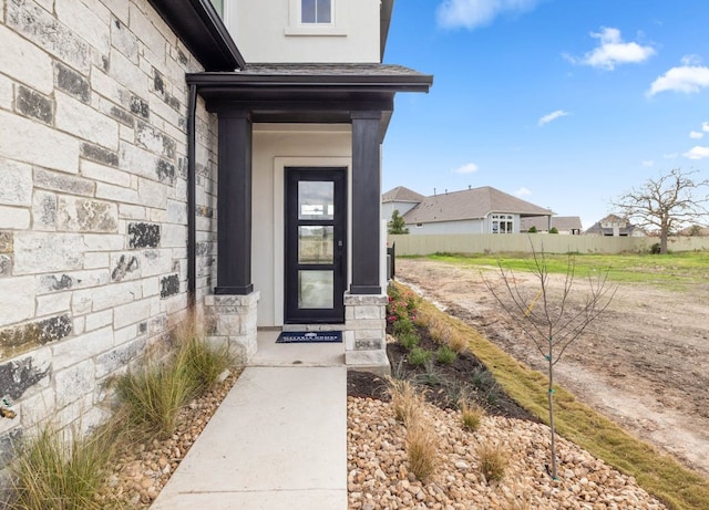 109 Flora Springs Cv, Liberty Hill, TX 78642 - doorway to property featuring stucco siding and stone siding