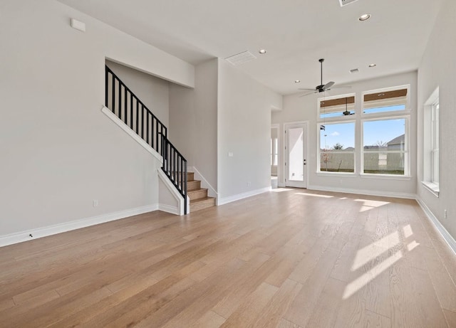 109 Flora Springs Cv, Liberty Hill, TX 78642 - unfurnished living room featuring ceiling fan, light wood-type flooring, stairs, recessed lighting, and baseboards