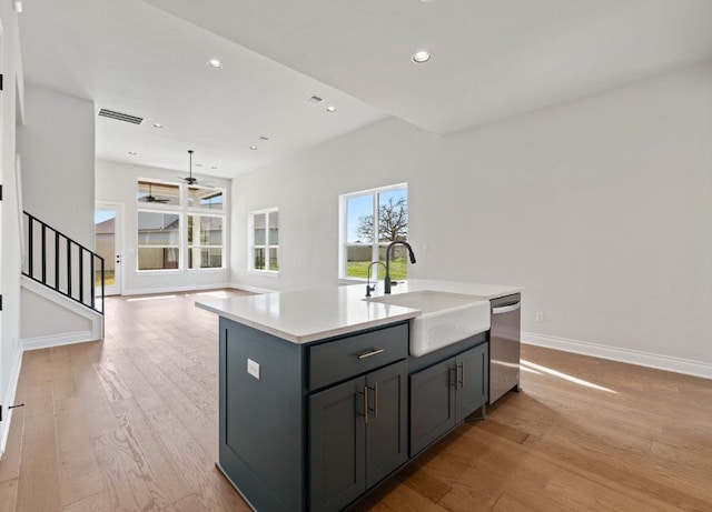 109 Flora Springs Cv, Liberty Hill, TX 78642 - kitchen featuring a sink, dishwasher, a ceiling fan, baseboards, and light wood-style floors