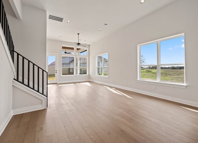 109 Flora Springs Cv, Liberty Hill, TX 78642 - unfurnished living room featuring ceiling fan, baseboards, hardwood / wood-style floors, stairway, and recessed lighting