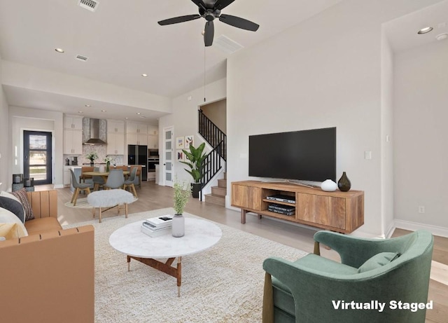 109 Flora Springs Cv, Liberty Hill, TX 78642 - living area featuring stairs, a ceiling fan, recessed lighting, baseboards, and light wood-style floors