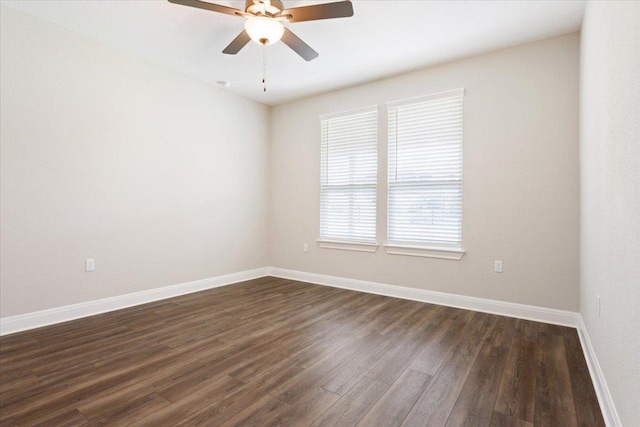 unfurnished room featuring baseboards, a ceiling fan, and dark wood-style flooring
