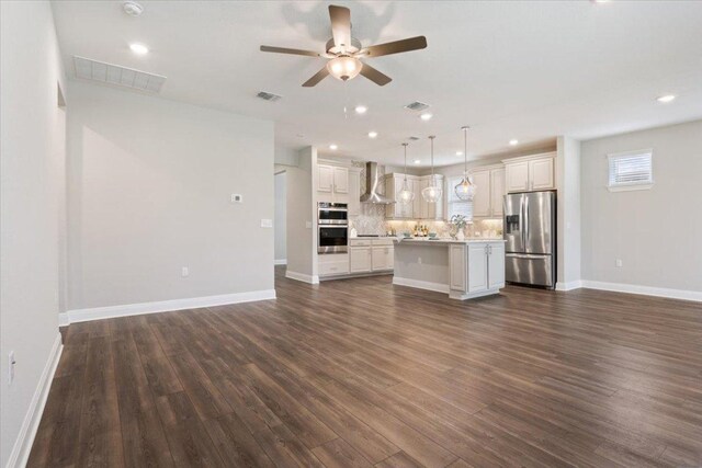 unfurnished living room featuring ceiling fan, visible vents, and dark wood-type flooring