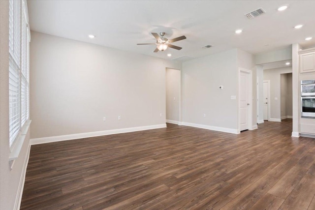 unfurnished living room featuring visible vents, dark wood-style flooring, baseboards, ceiling fan, and recessed lighting