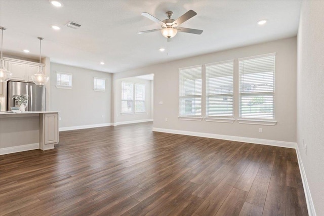unfurnished living room featuring visible vents, dark wood-style flooring, baseboards, ceiling fan, and recessed lighting