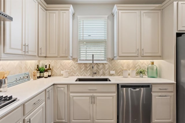 kitchen featuring decorative backsplash, light countertops, white cabinetry, a sink, and stainless steel appliances
