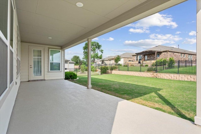 view of patio with fence and a residential view
