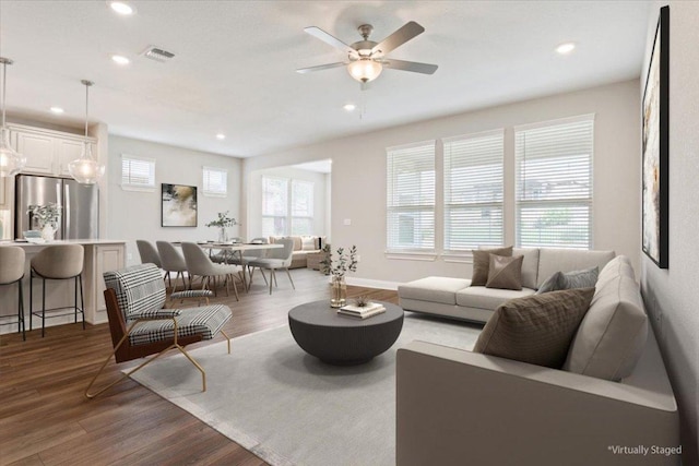 living area with visible vents, recessed lighting, ceiling fan, and wood finished floors
