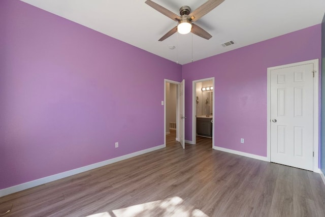 3322 Silk Oak Dr, Austin, TX 78748 - unfurnished bedroom with wood finished floors, baseboards, ensuite bath, and ceiling fan