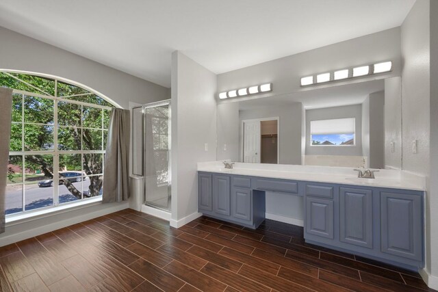 3322 Silk Oak Dr, Austin, TX 78748 - full bath with baseboards, a stall shower, double vanity, and wood finished floors