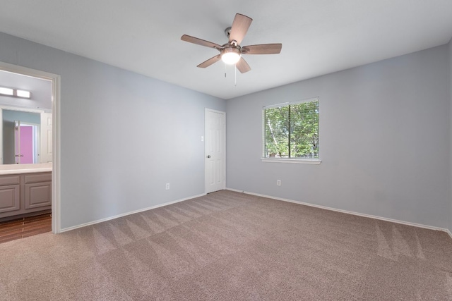 unfurnished room featuring a ceiling fan, carpet floors, and baseboards