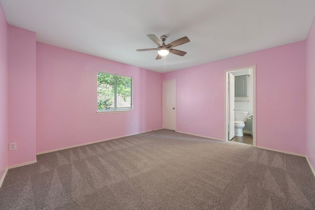 unfurnished bedroom with baseboards, a ceiling fan, connected bathroom, and carpet