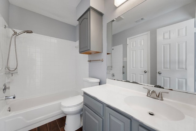 full bath featuring visible vents, tub / shower combination, toilet, wood finished floors, and vanity